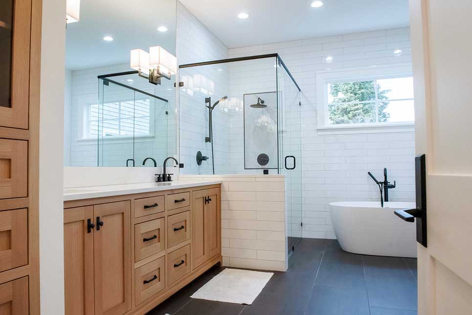 custom bathroom with tile floor walk-in shower and soaker tub by Landry & Co