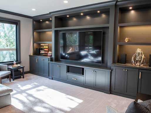 media room with custom cabinetry built by Landry and co