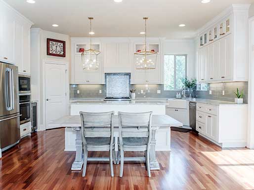 kitchen with wood floors and custom light fixtures designed and built by Landry and co